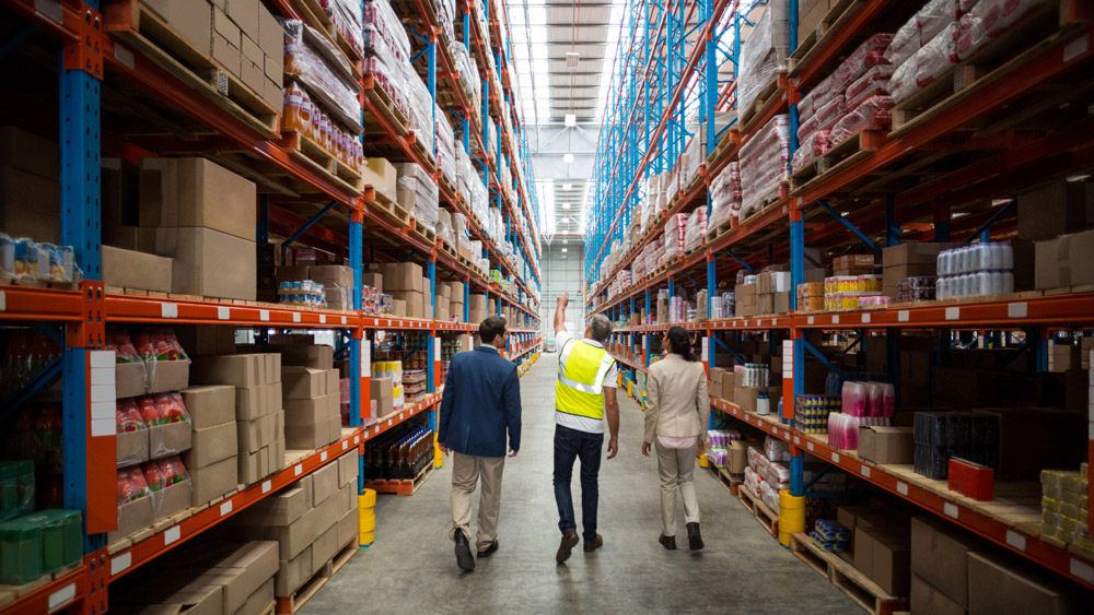 warehouse workers walking down inventory isle